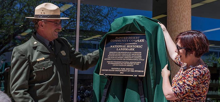 A plaque commemorating the National Historic Landmark designation for the Painted Desert Community Complex being presented. | NPS Photo
