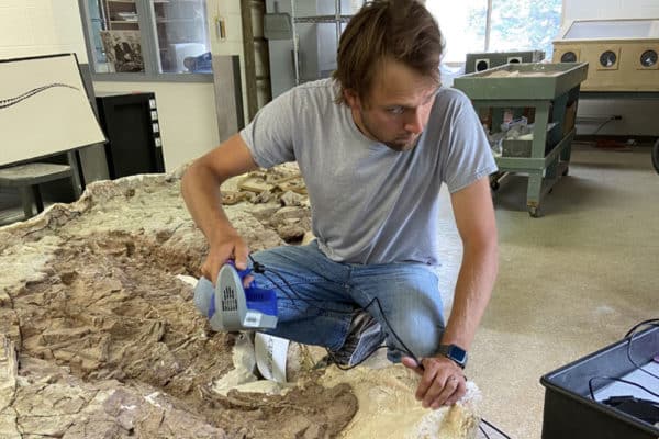 Adam Marsh, Ph.D., scanning fossil with 3D scanner